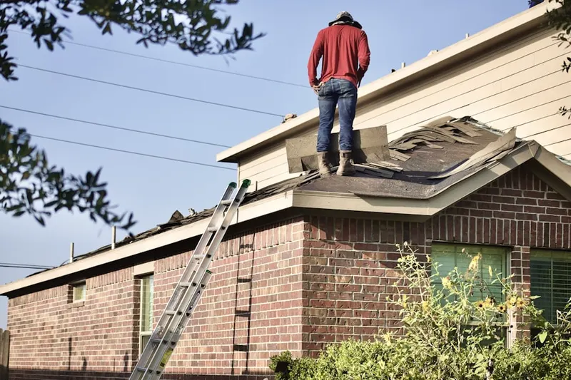 Professional roofer working on a residential roof in Hunters Green